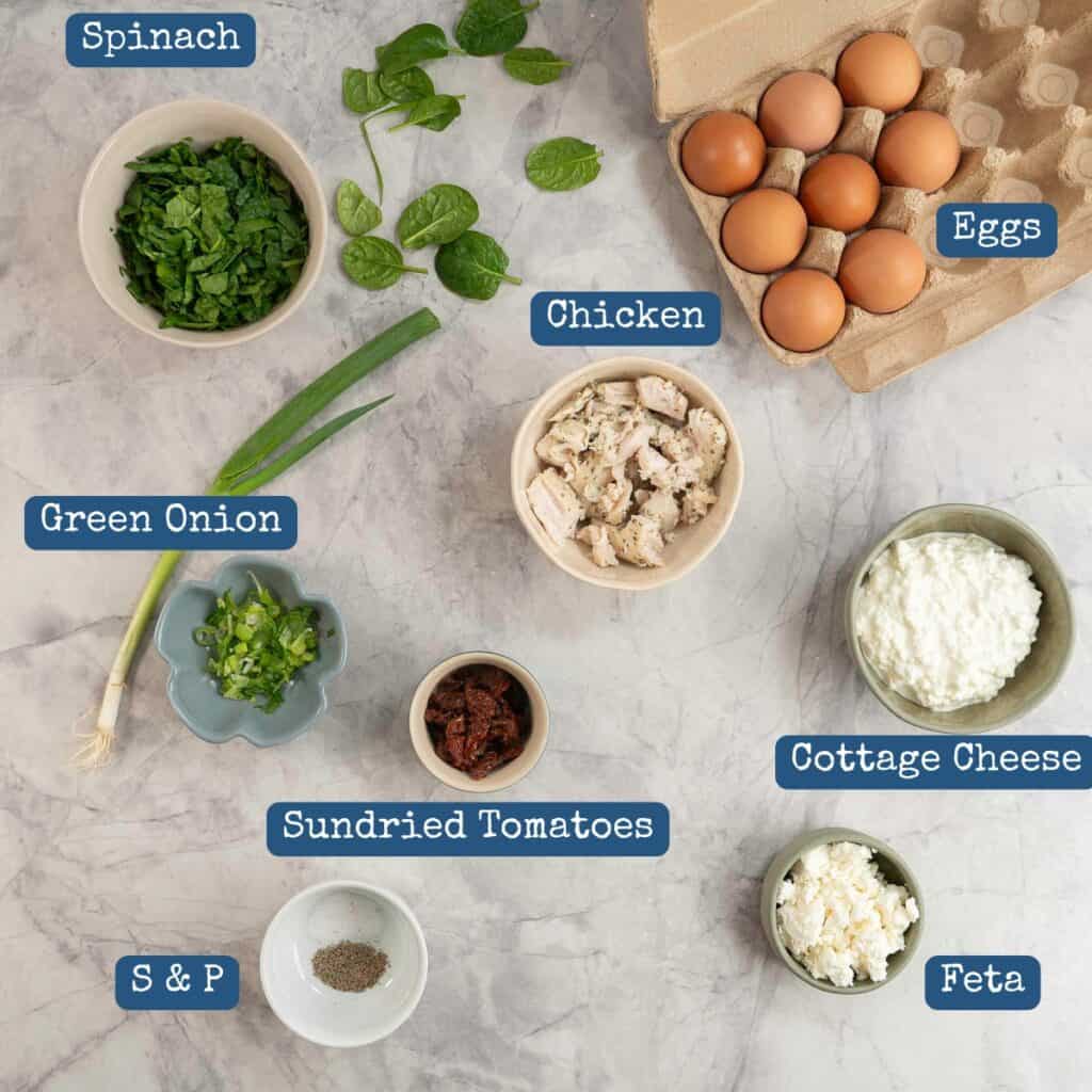 Ingredients for cottage cheese egg muffins with text overlay on marble bench top.