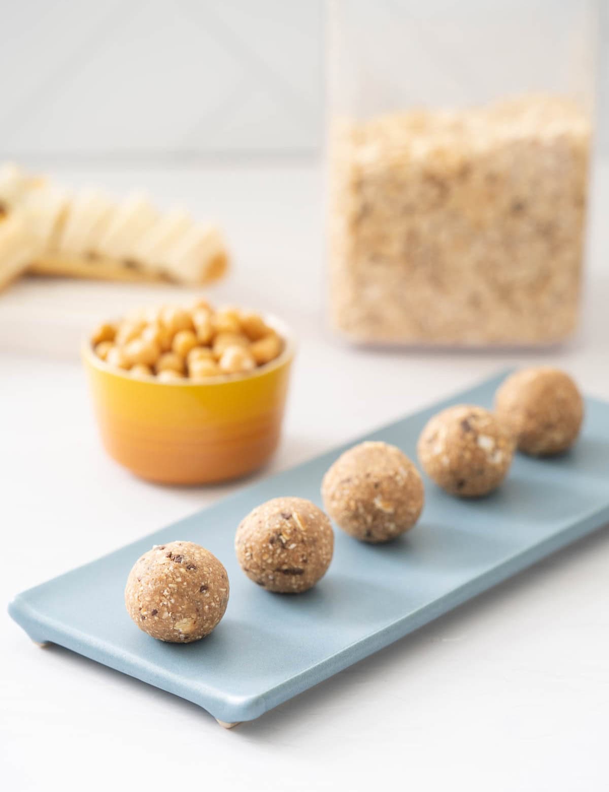 Five protein balls on a blue plate.
