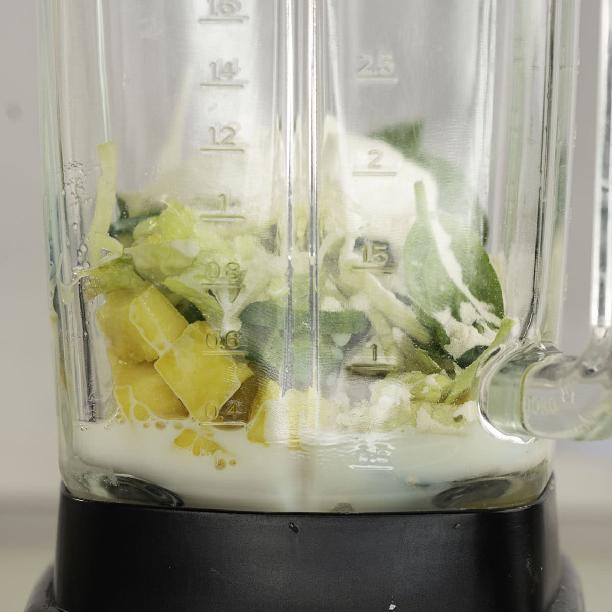 Ingredients for green smoothie in a blender.