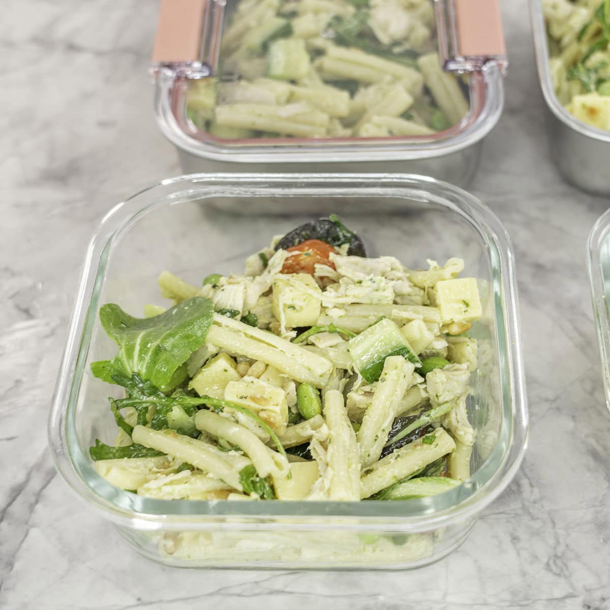 Glass square container with protein salad inside.