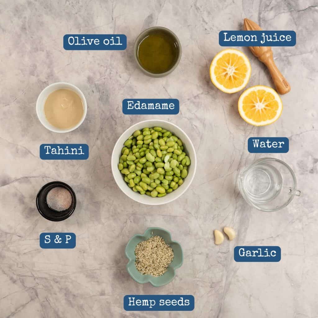 Ingredients for homemade hummus on bench top with text overlay.