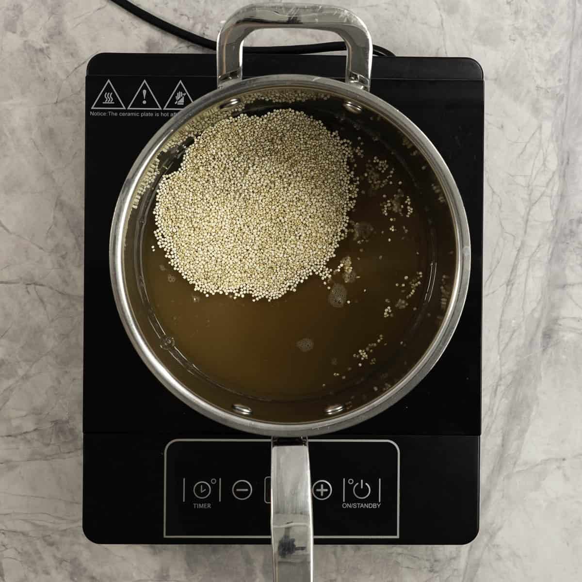 Quiona and broth on an electric element.