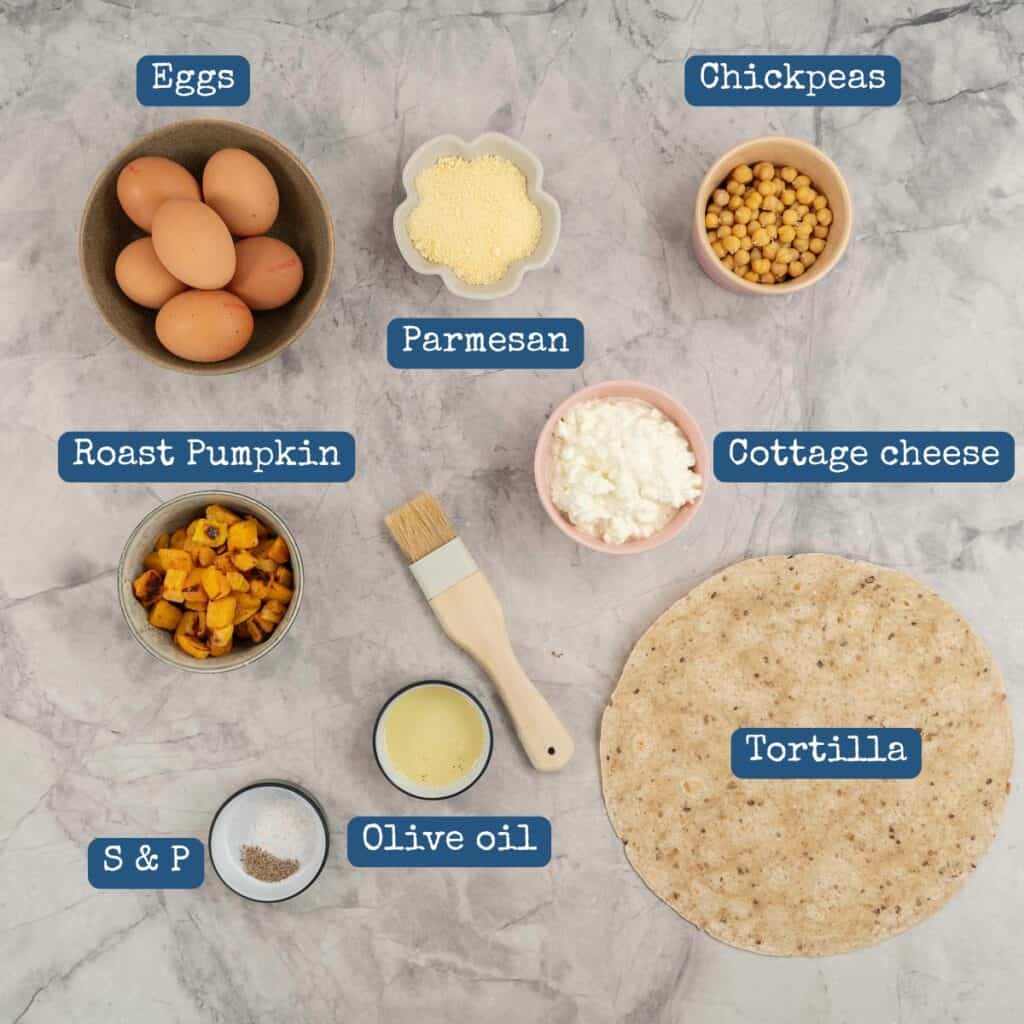 Ingredients for tortilla quiche on bench top with text overlay.