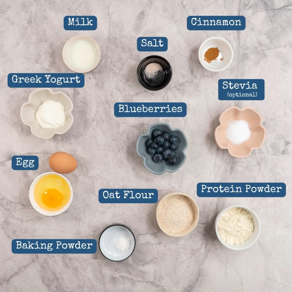 Ingredients for protein pancake bowls on benchtop with text overlay.