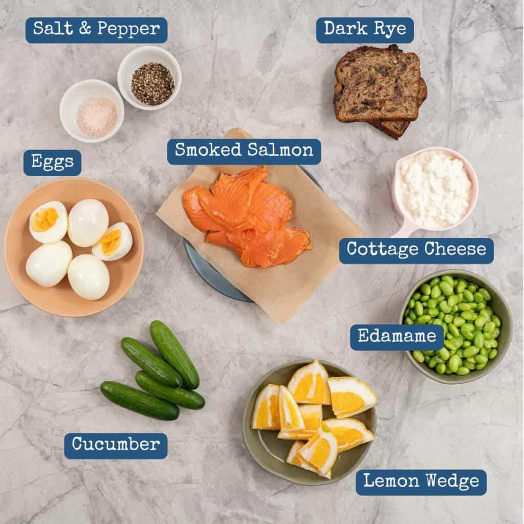 Ingredients for salmon bento box on benchtop with text overlay.
