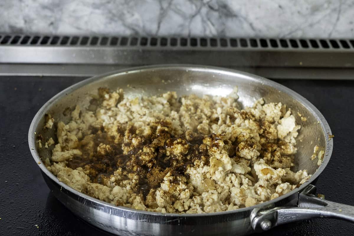 Chicken mince in saucepan on stovetop.
