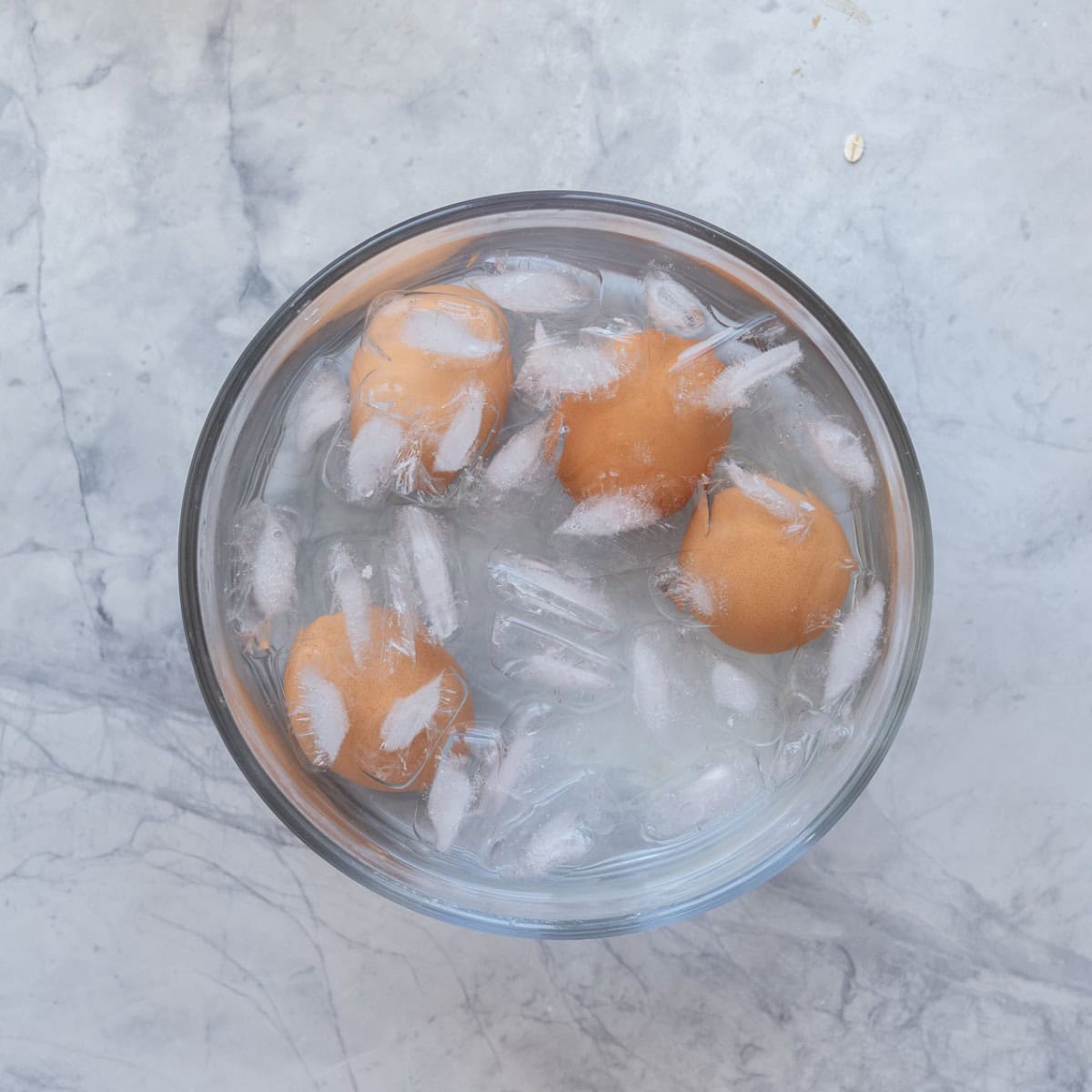 4 eggs in a bowl of ice and water.