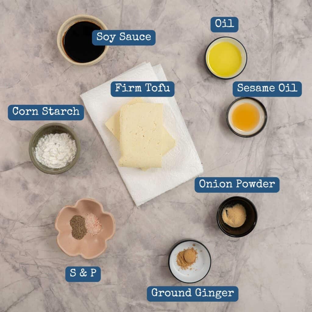 Ingredients for crispy tofu on marble bench top with text overlay.